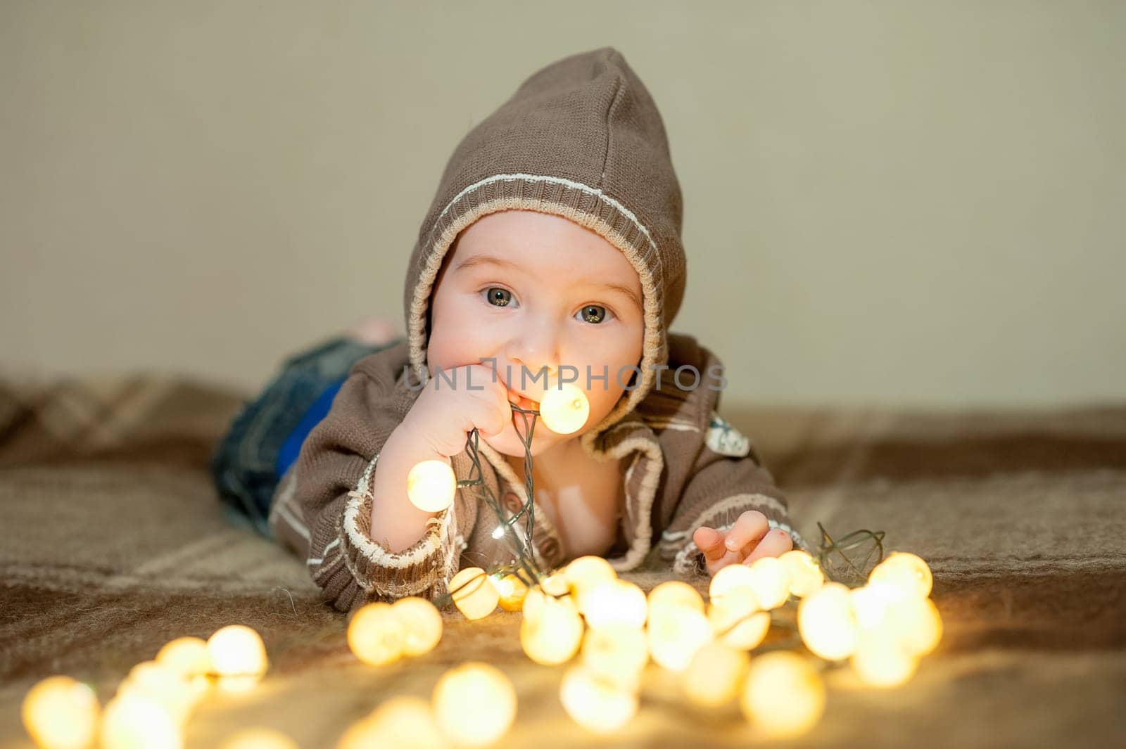 Cute baby playing on the bed, smiling and posing to the camera