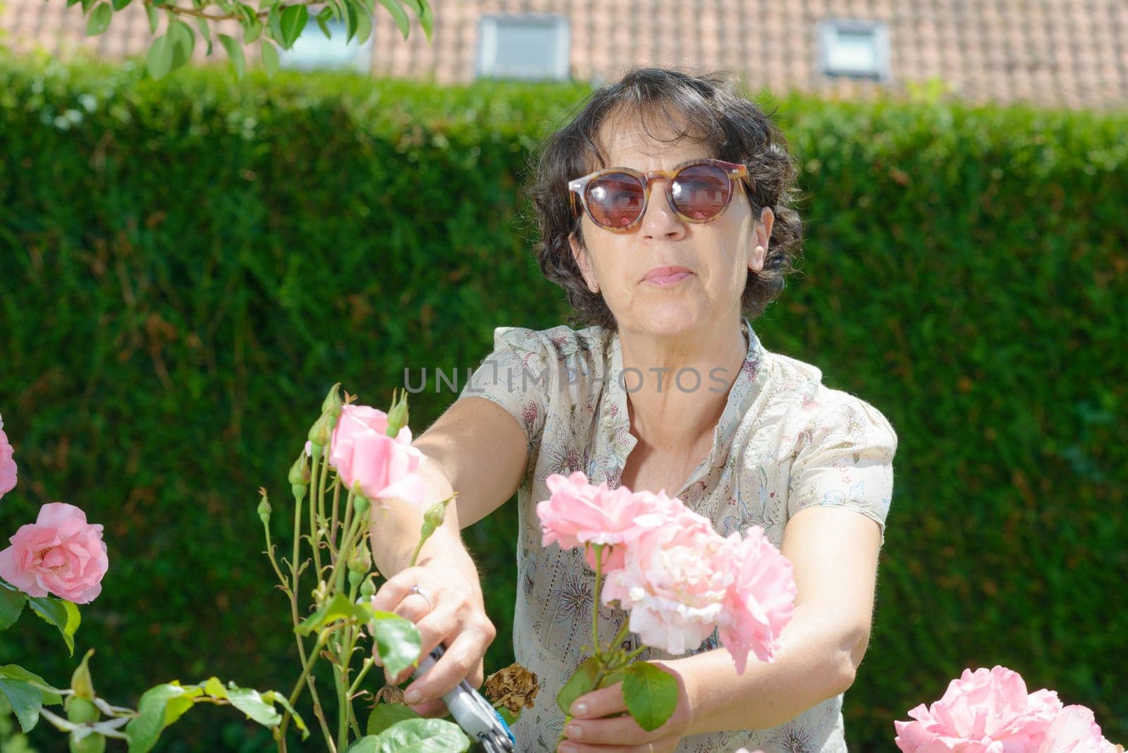 a middle-aged woman with sunglasses in the garden