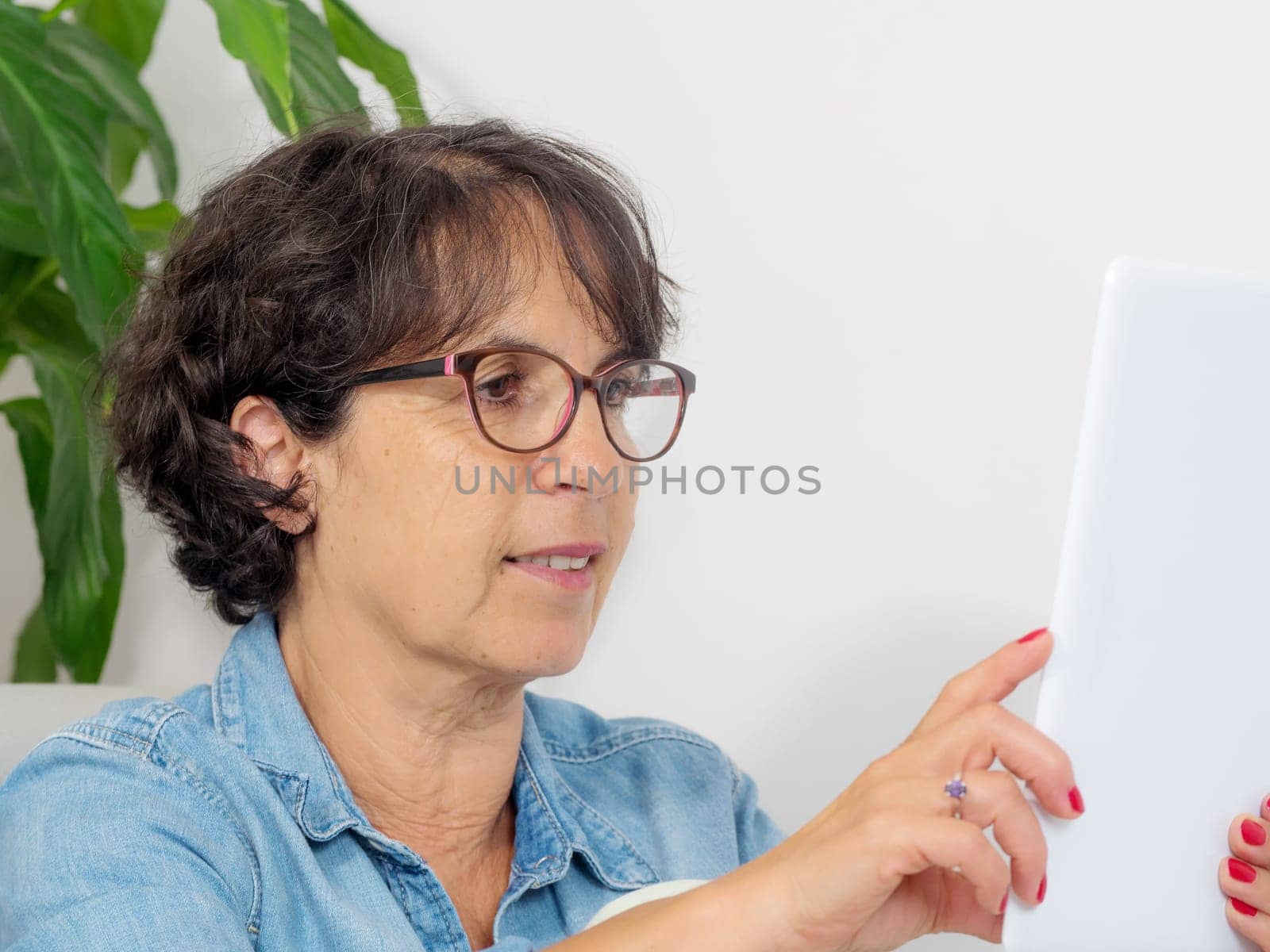 a portrait of a mature woman with a tablet