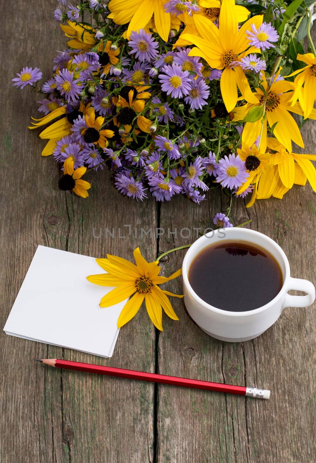 pencil, coffee and bouquet of wild flowers, on a wooden table, a subject flowers and drinks, seasons spring and summer