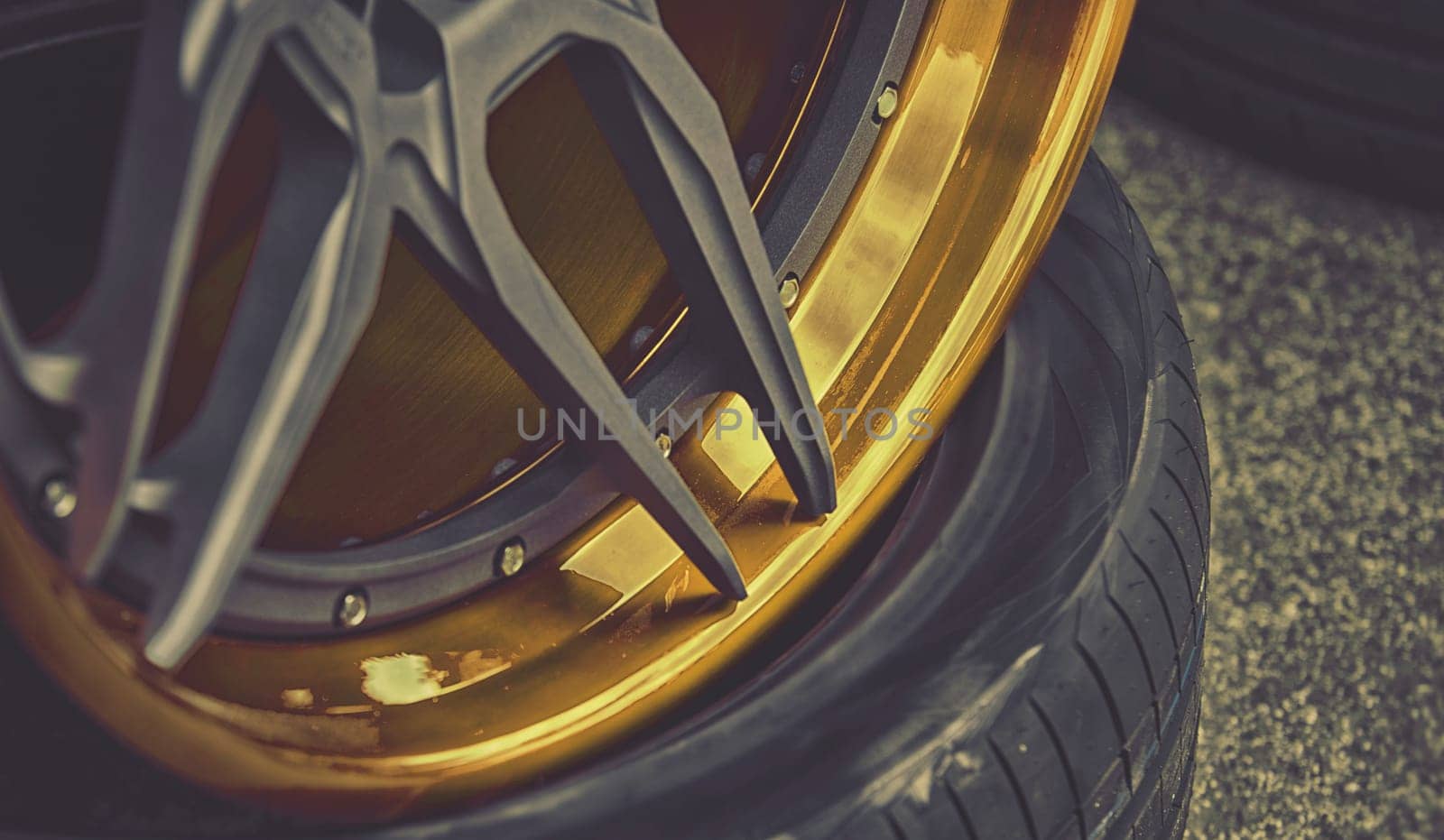 closeup detail of gold aluminum car wheel