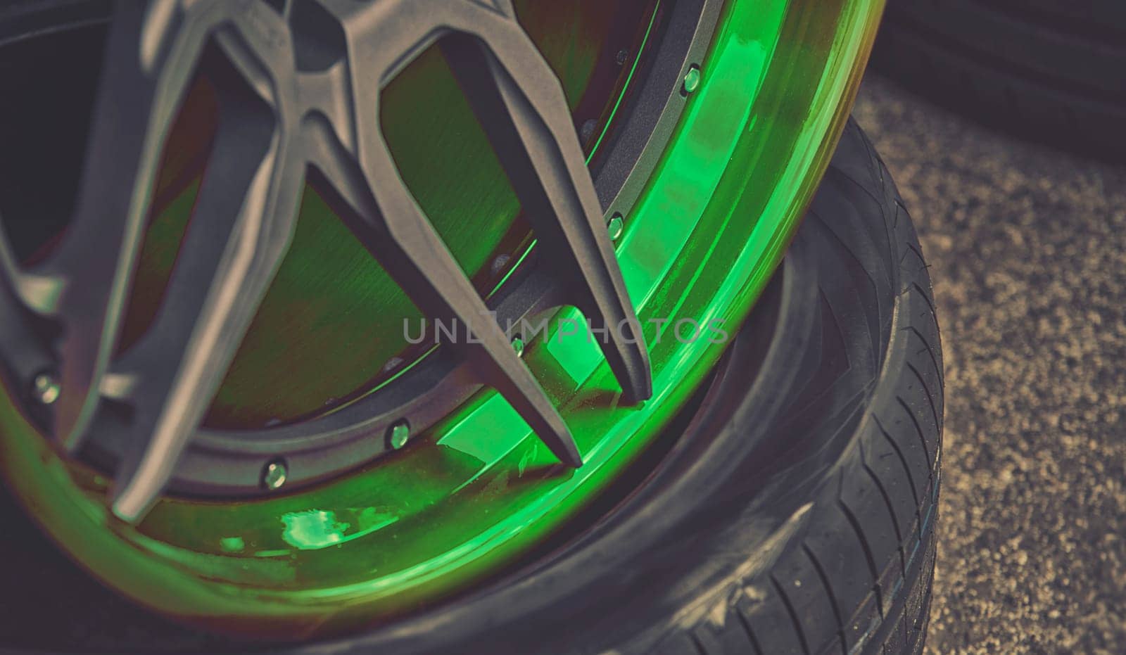 closeup detail of green aluminum car wheel