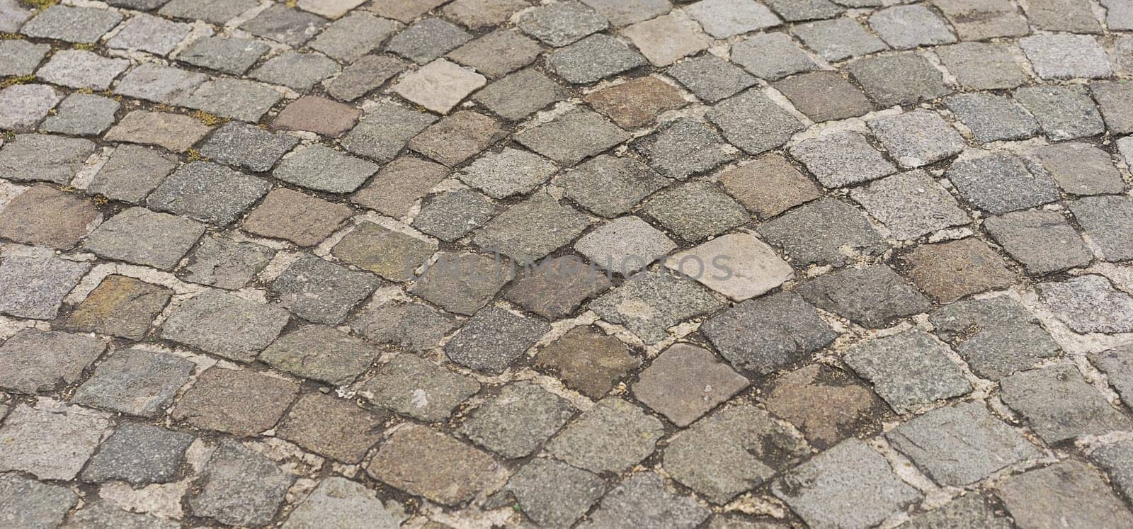 Panorama old  traditional european style cobblestone road texture background with granite blocks, stones and brickwork pattern