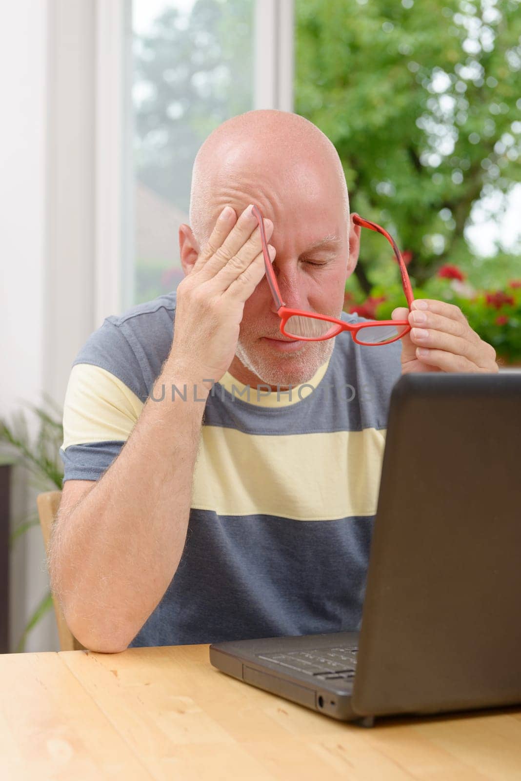 a mature man with headache