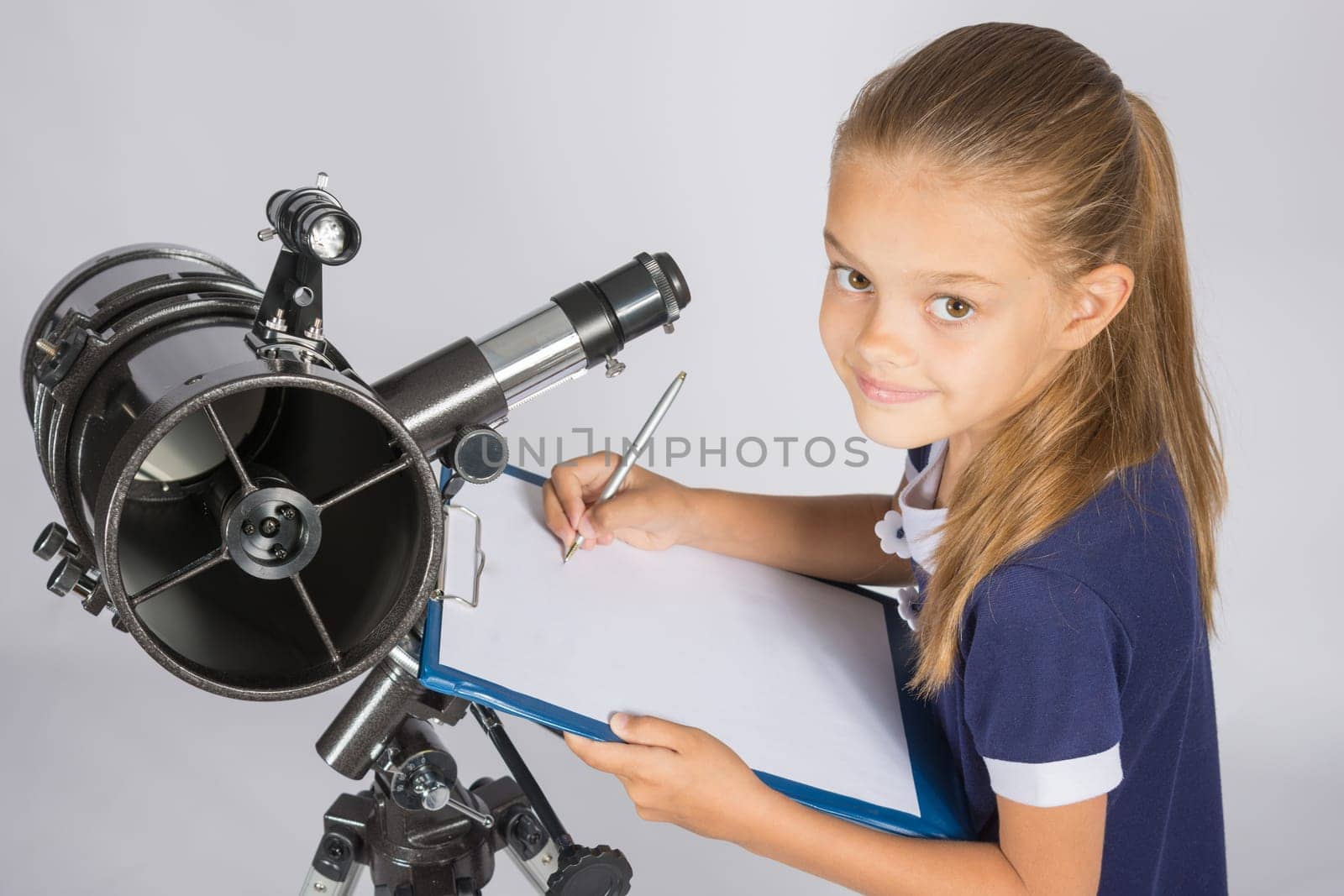 Young Astronomer writes the results of observations in the document