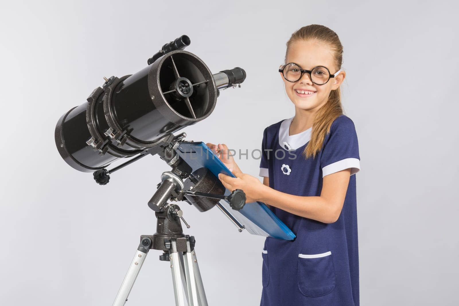 The young astronomer happy to look through the telescope recording observations