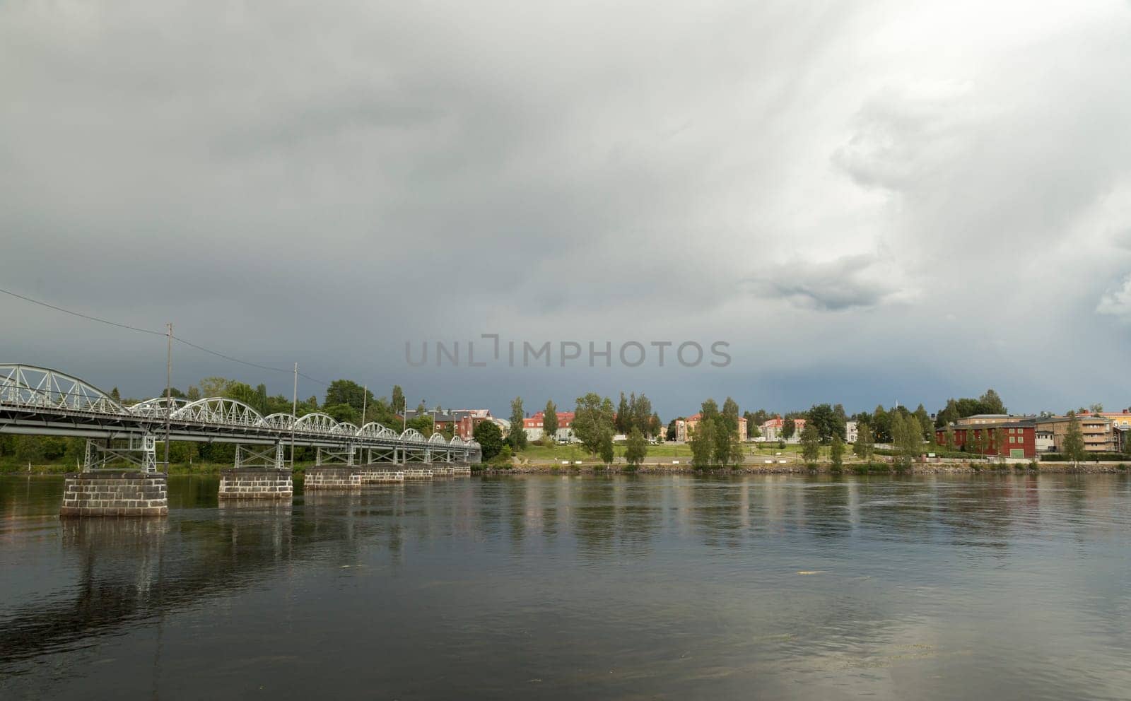 Bridge and River in Umea, Sweden with a cloudy sky.