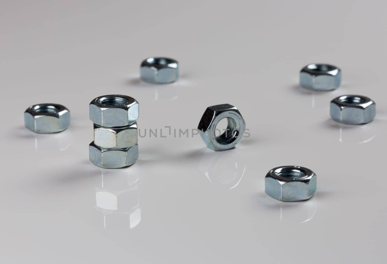 Hardware Nuts Close Up on gray background.