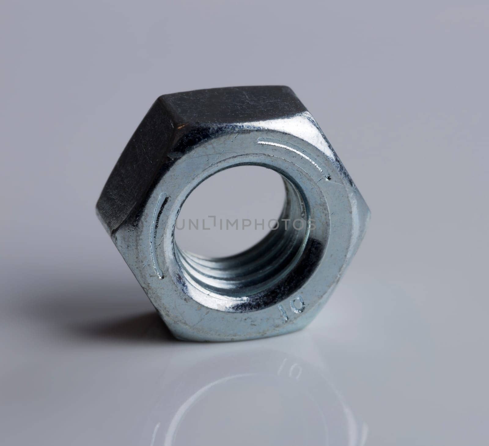 Hardware Nut Close Up on gray background.