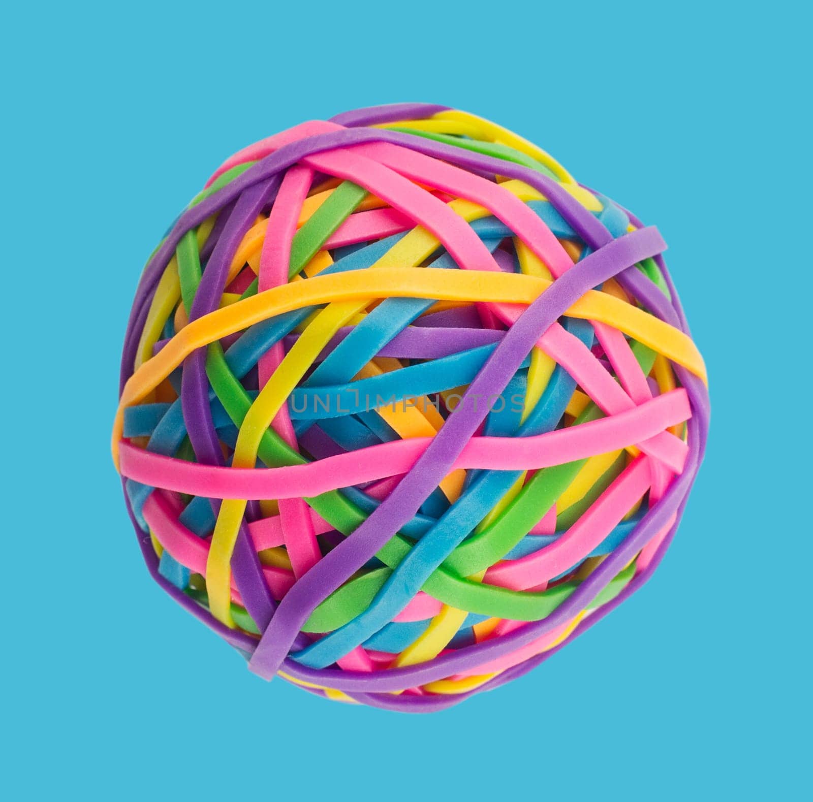 Rubber elastic band ball on light blue background