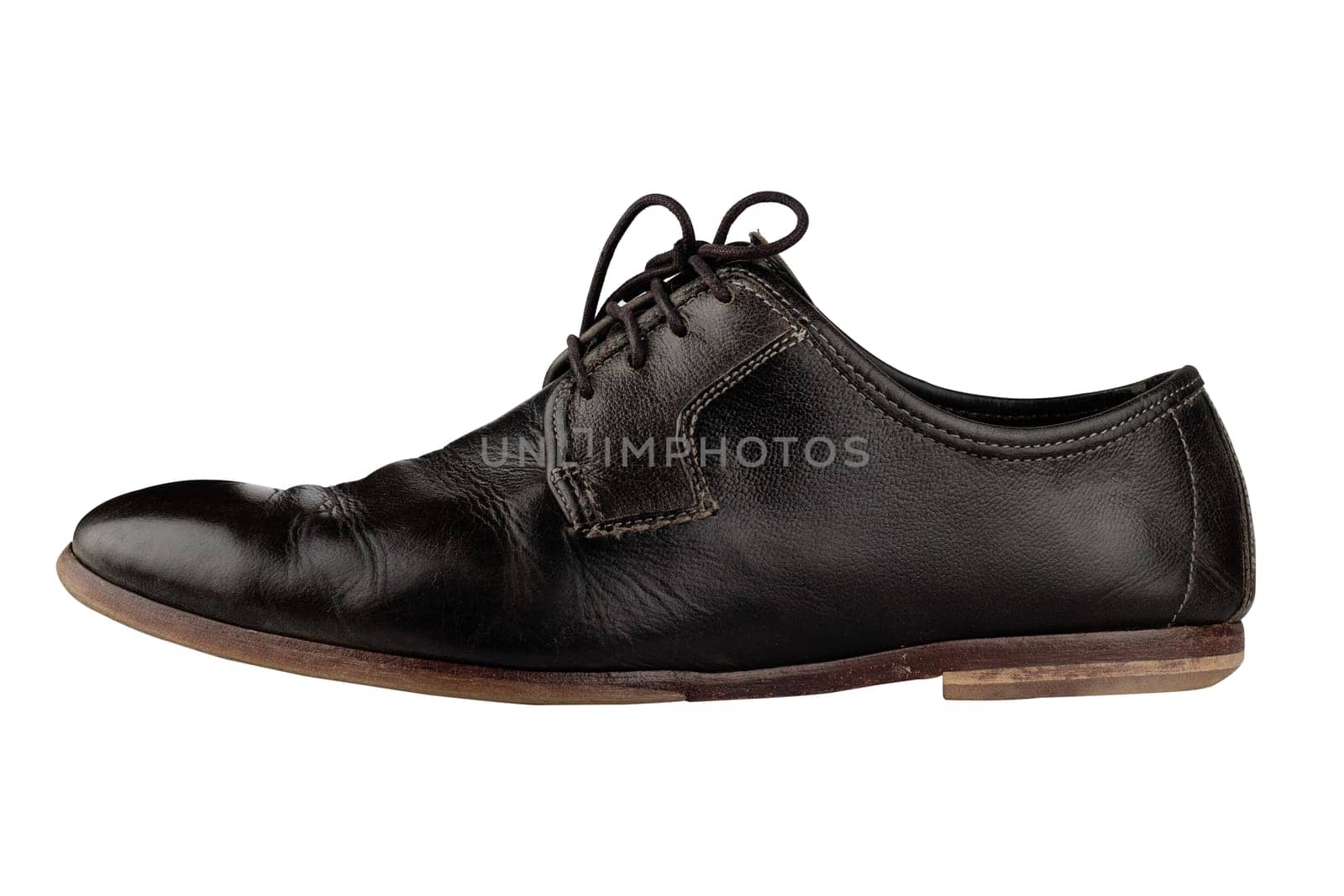 Horizontal side view of an elegant old black leather shoe isolated on white background