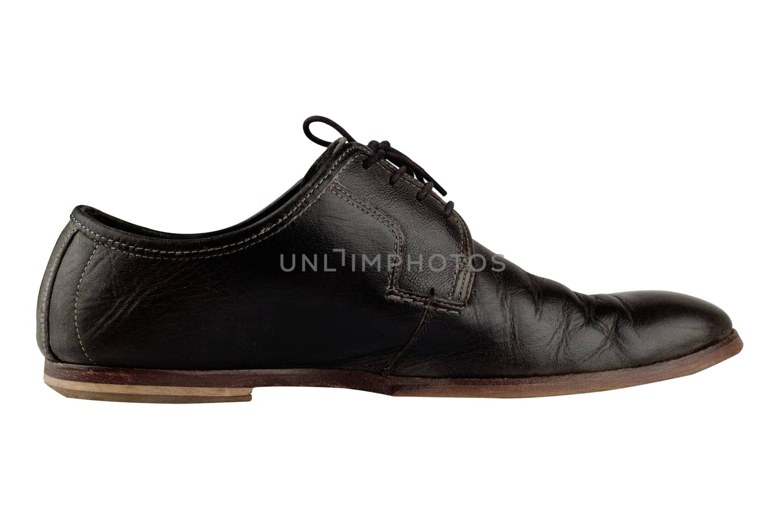 Horizontal side view of an elegant old black leather shoe isolated on white background