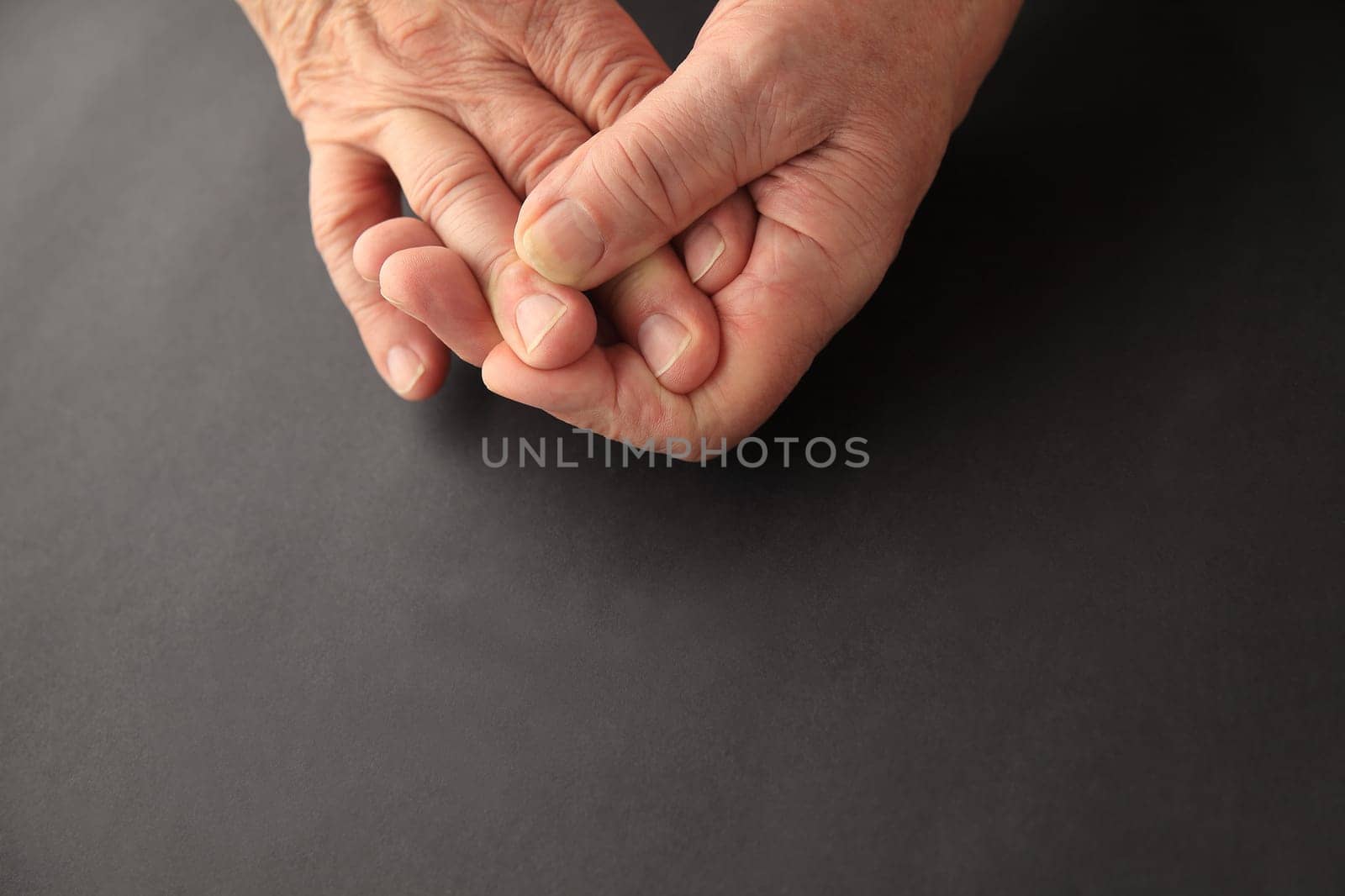 Man’s hands on black background with copy space