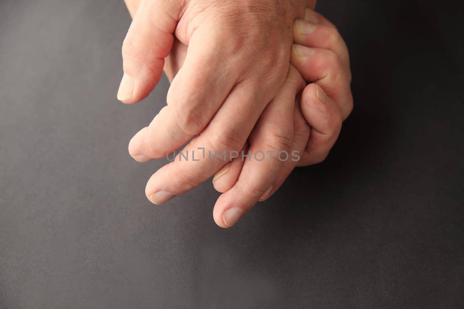 Senior man holding his painful hand