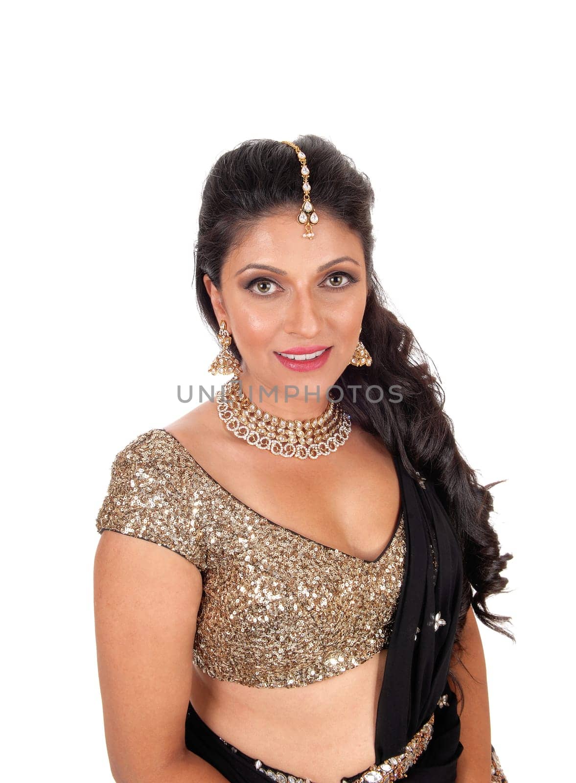 A gorgeous woman with long curly black hair standing in a portrait image.looking into the camera, isolated for white background..