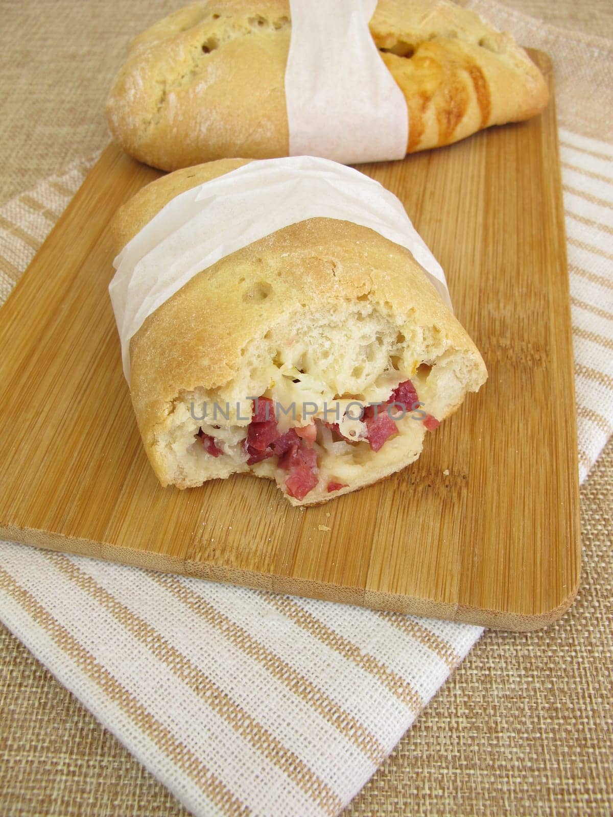 Hand bread street foodwith ham cubes and cheese