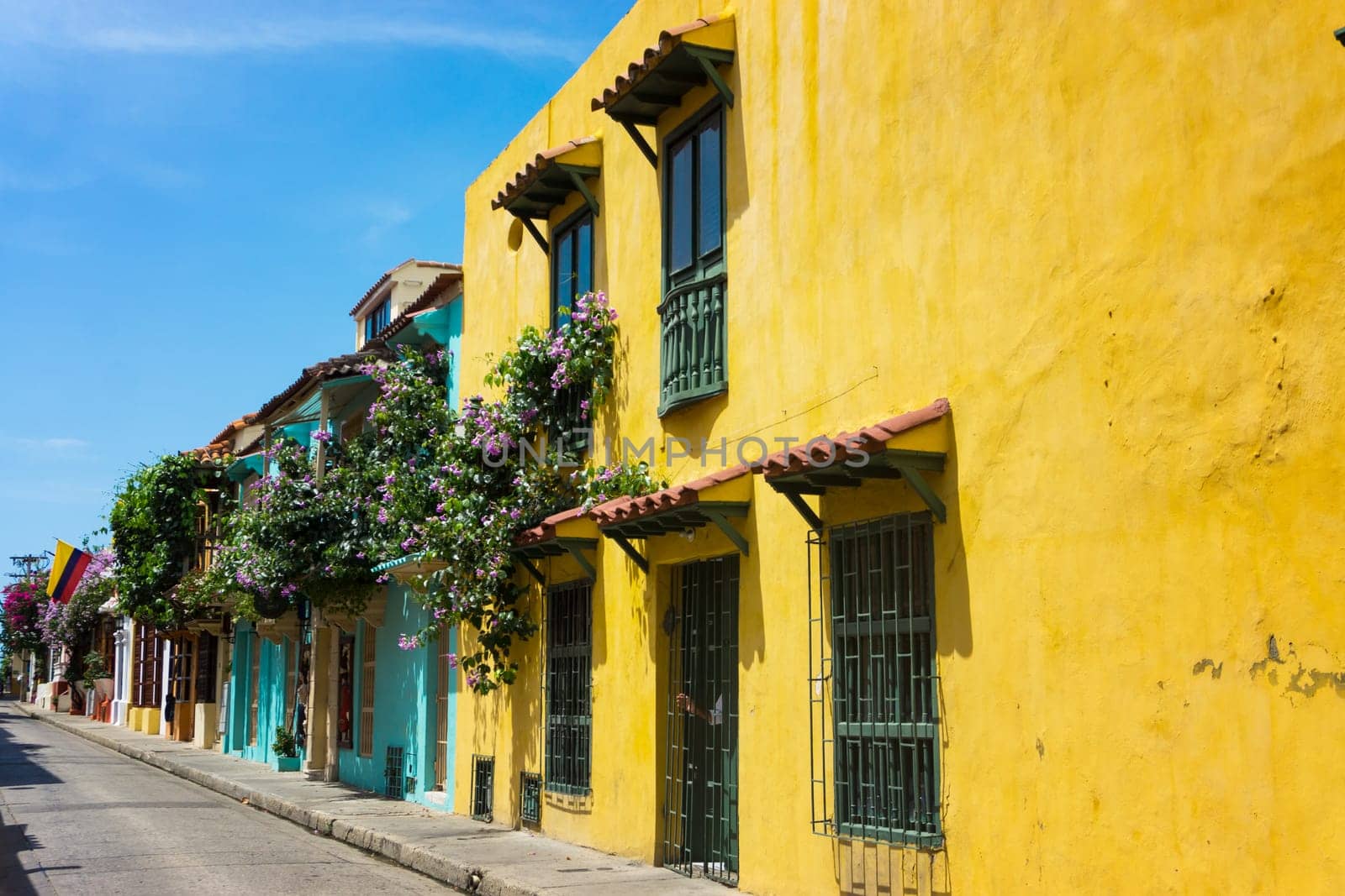 Colorful street with colonial architecture and a Colombian flag in Cartagena, Colombia