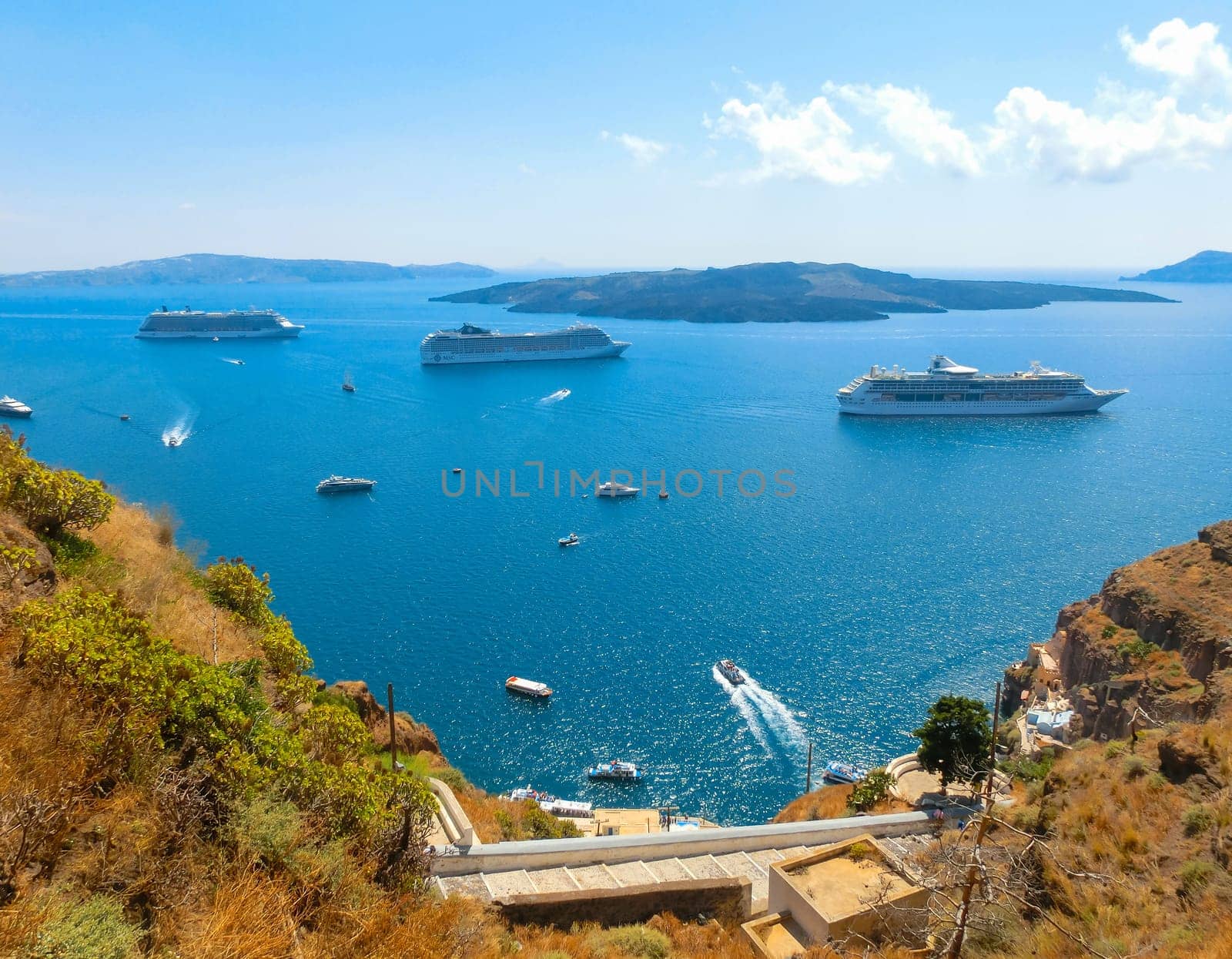 Santorini, Greece - June 10, 2015: The beautiful view of marina bay with cruise ships at the sea