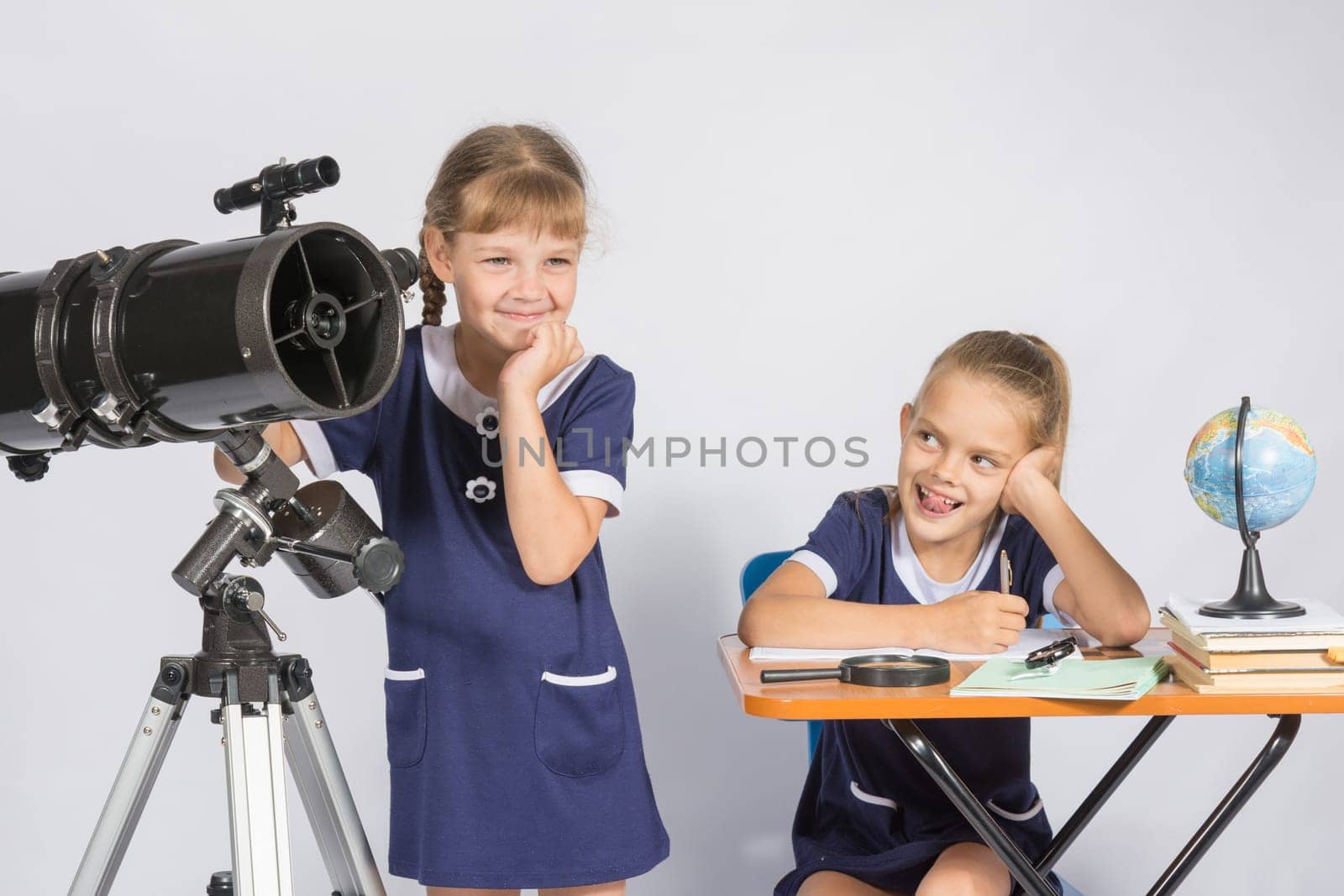 Girl mysteriously astronomer looks into the distance, a classmate with a smile looked at her