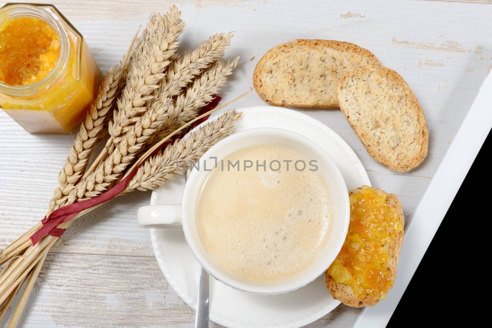 a breakfast with toast and orange jam