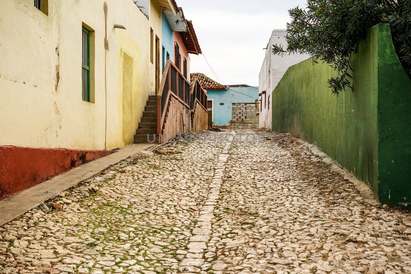 multicolored house along the road with cobblestone