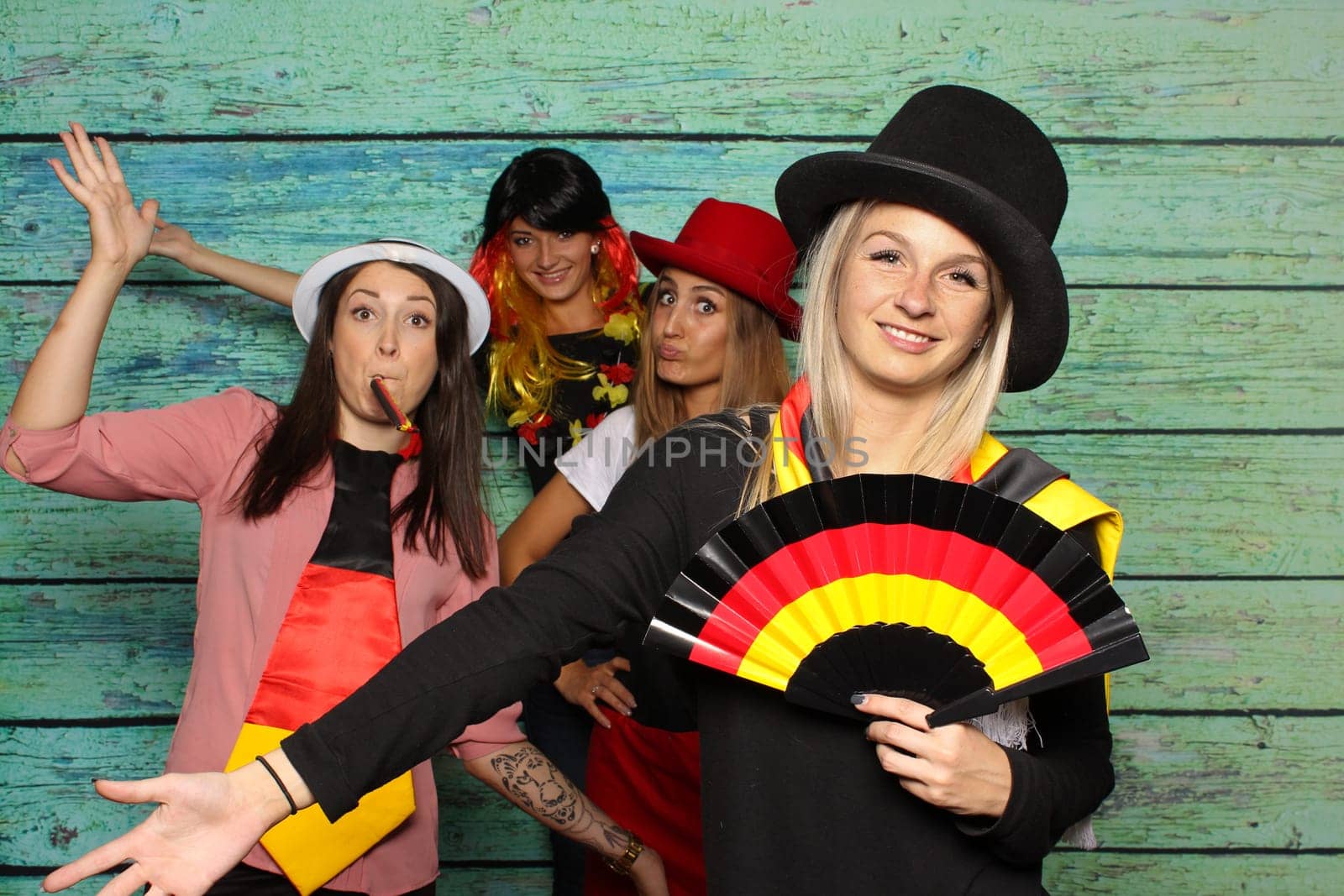 Funny football fans in front of a photo box