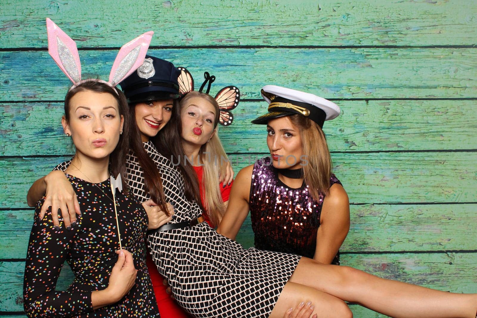 Cute girls with headgear in front of a photo box