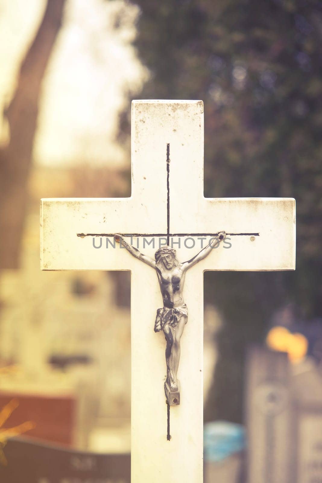 close up on cross of jesus christ on cemetery