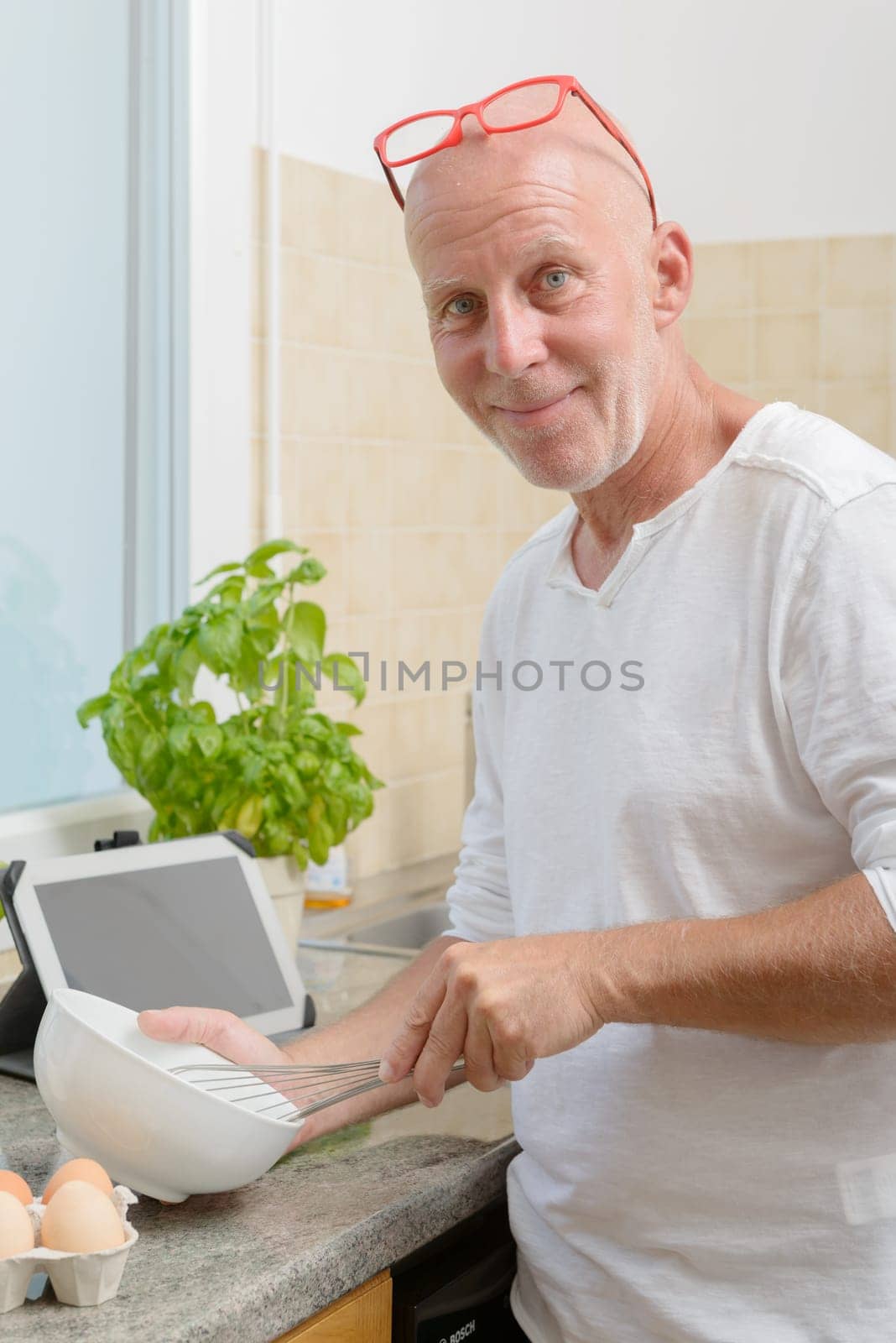 a mature man in the kitchen