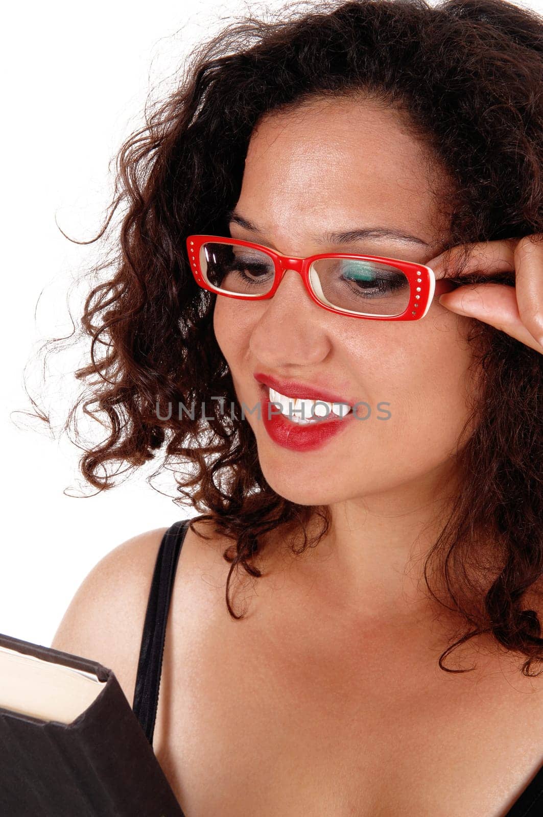 A closeup image of a beautiful young woman wearing red glasses and.holding a book in her hands, isolated for white background..