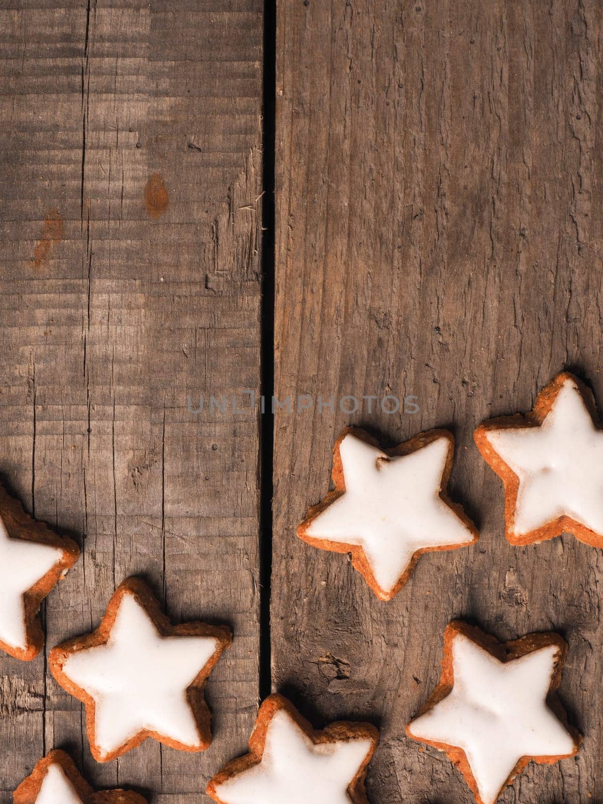 Cinnamon stars on a wooden background with space for text