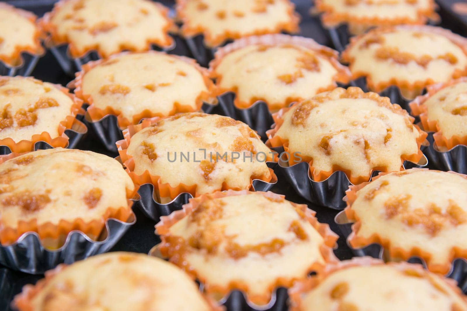 Freshly baked muffins in metal tins