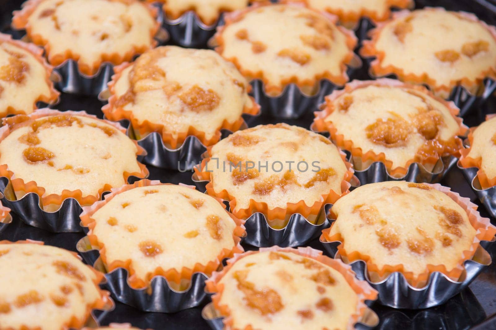 A view of several freshly baked cakes in metal tins