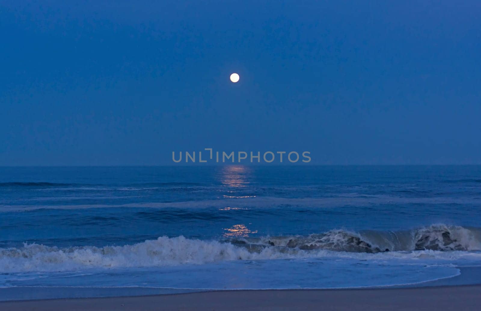 Moon Reflections in the Twilight on the Shore of Cape Hatteras in North Carolina