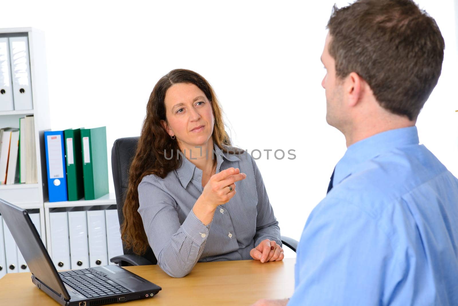 angry female boss in serious conversation with clerk