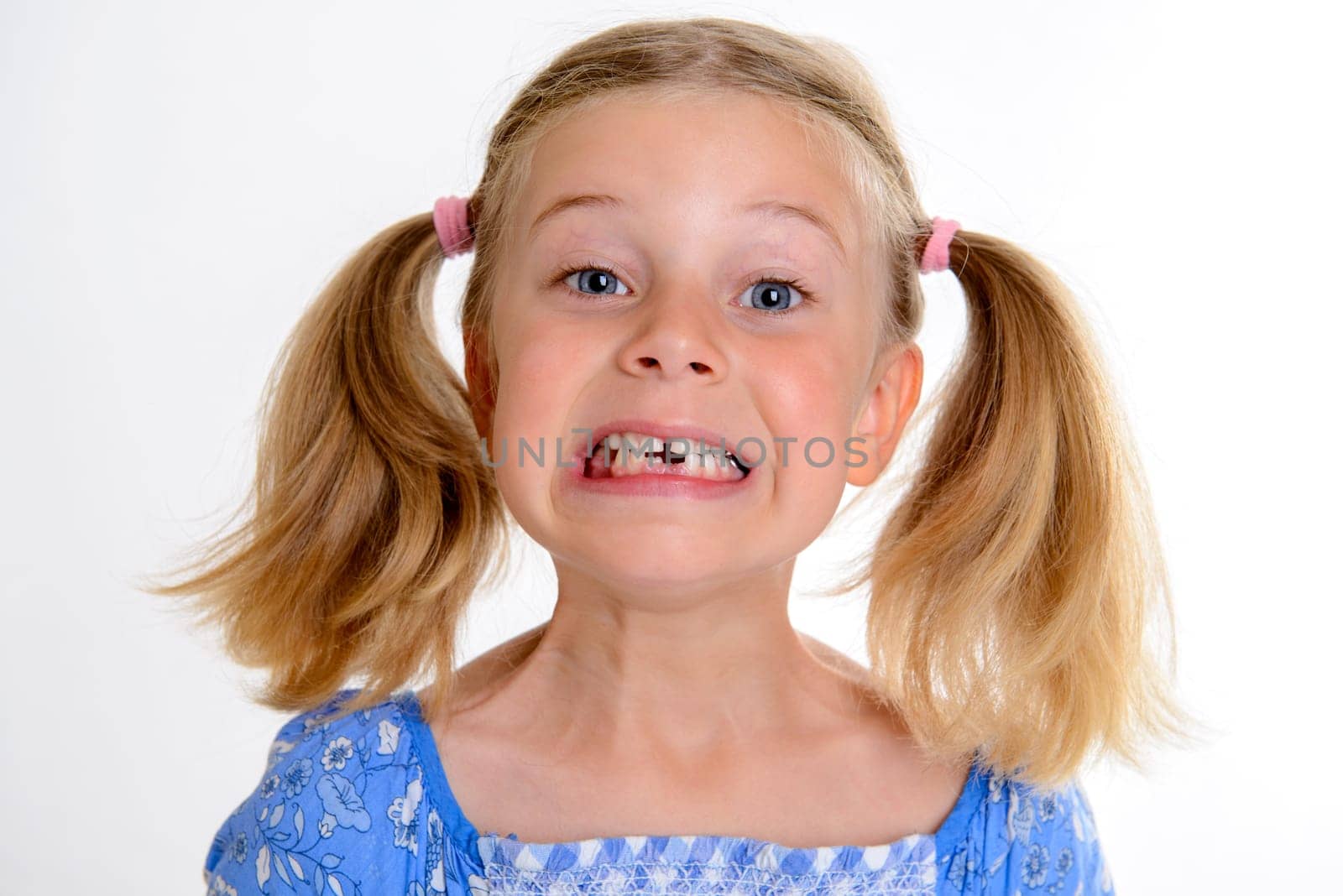little funny girl with space width looking in to the camera