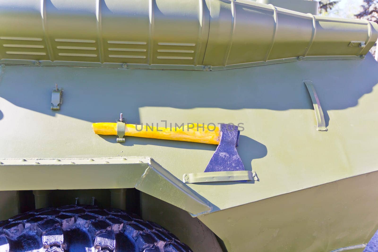 Military machine at the exhibition under open sky with ax
