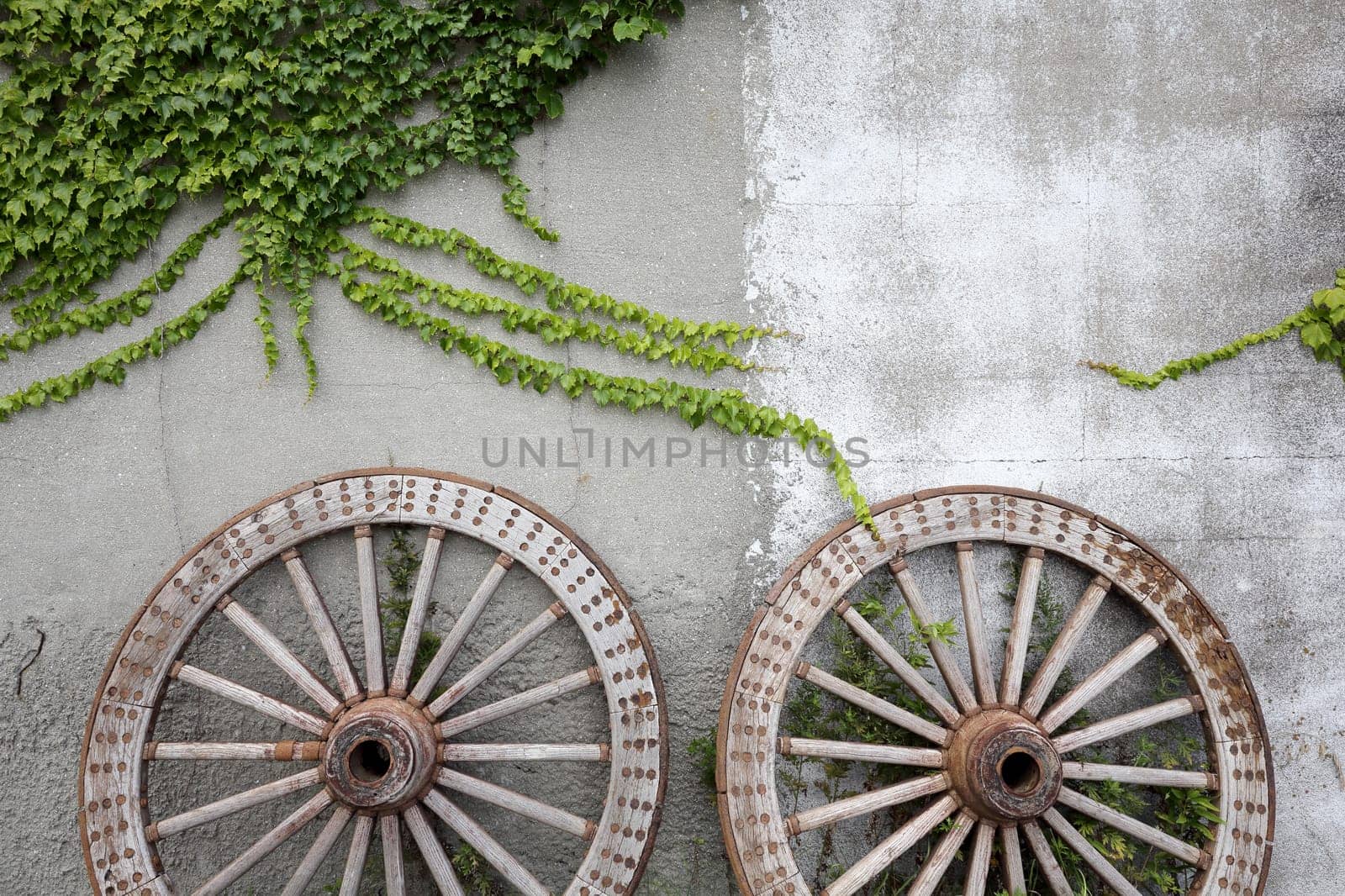 Wooden wheel on old brick wall