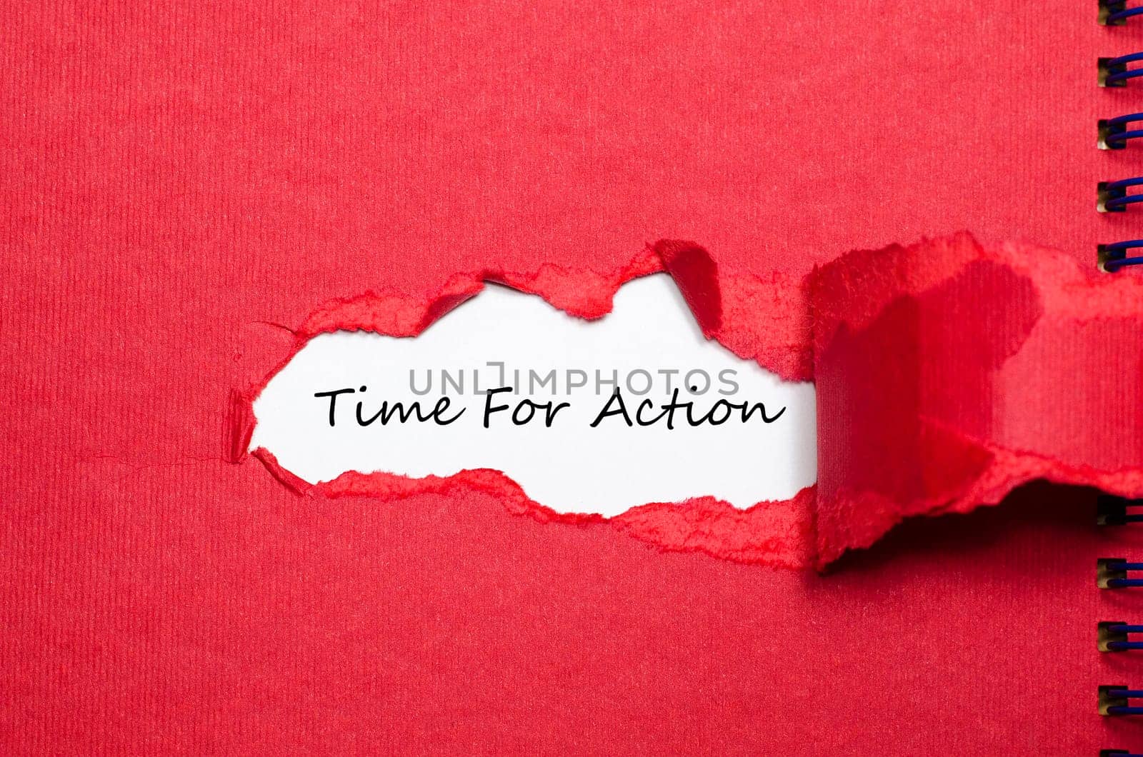 The word time for action appearing behind torn paper