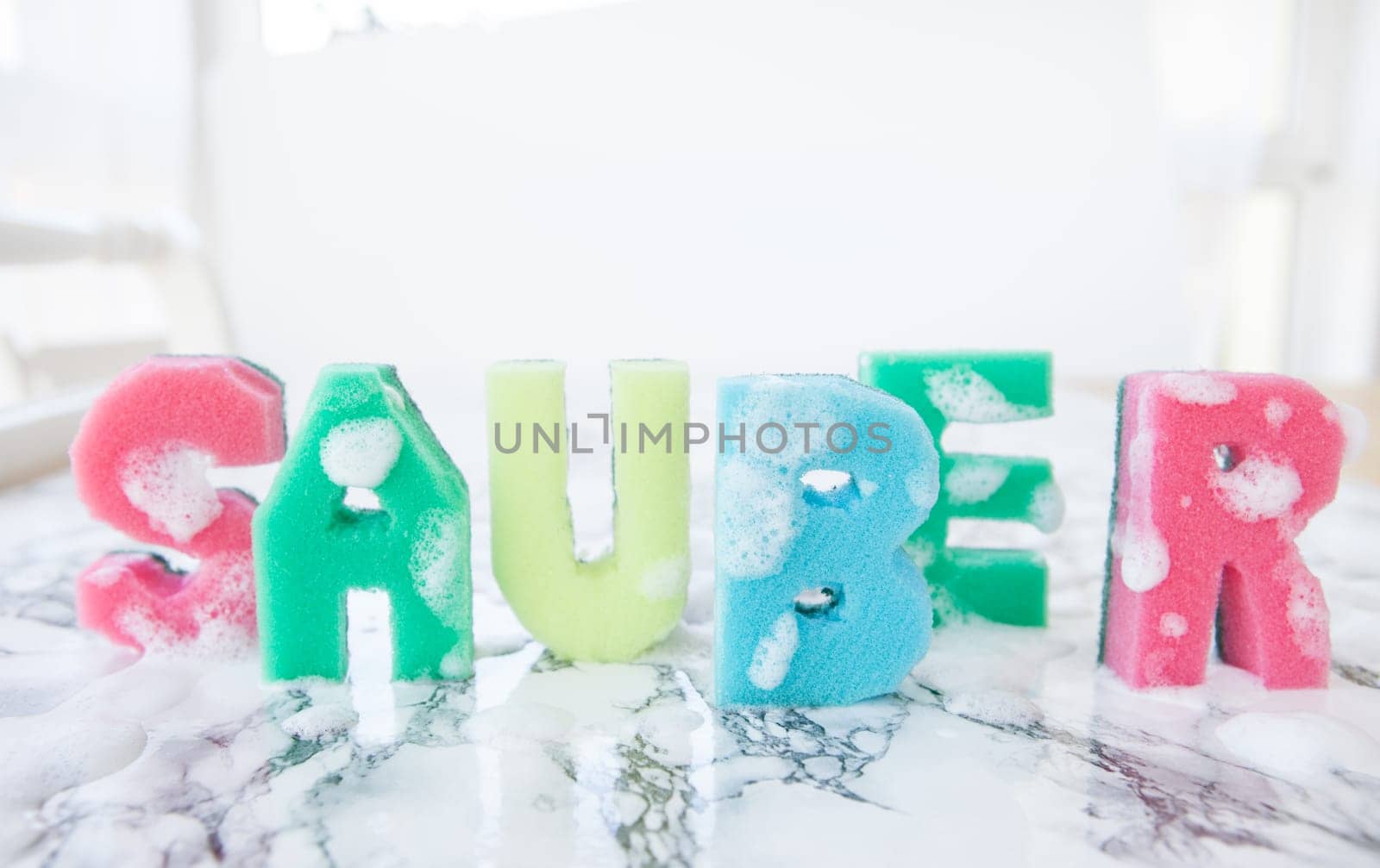 Plaster sponge as lettering Clean on background made of marble