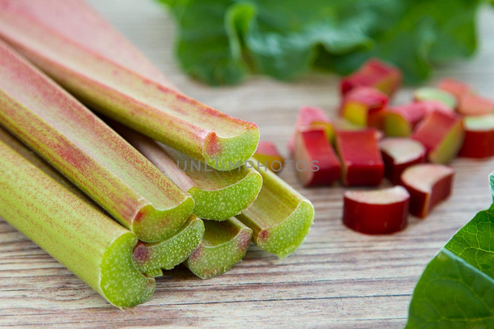 Fresh rhubarb stems on wooden board