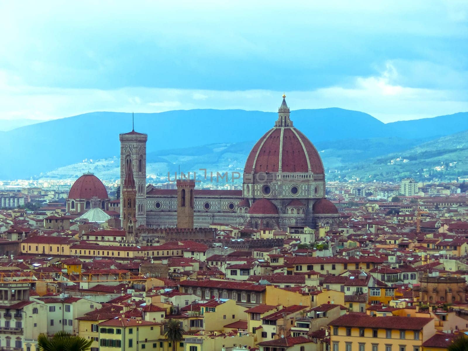 View of the Cathedral Santa Maria del Fiore in Florence, Italy - Florence's cathedral stands tall over the city with its magnificent Renaissance dome designed by Filippo Brunelleschi.