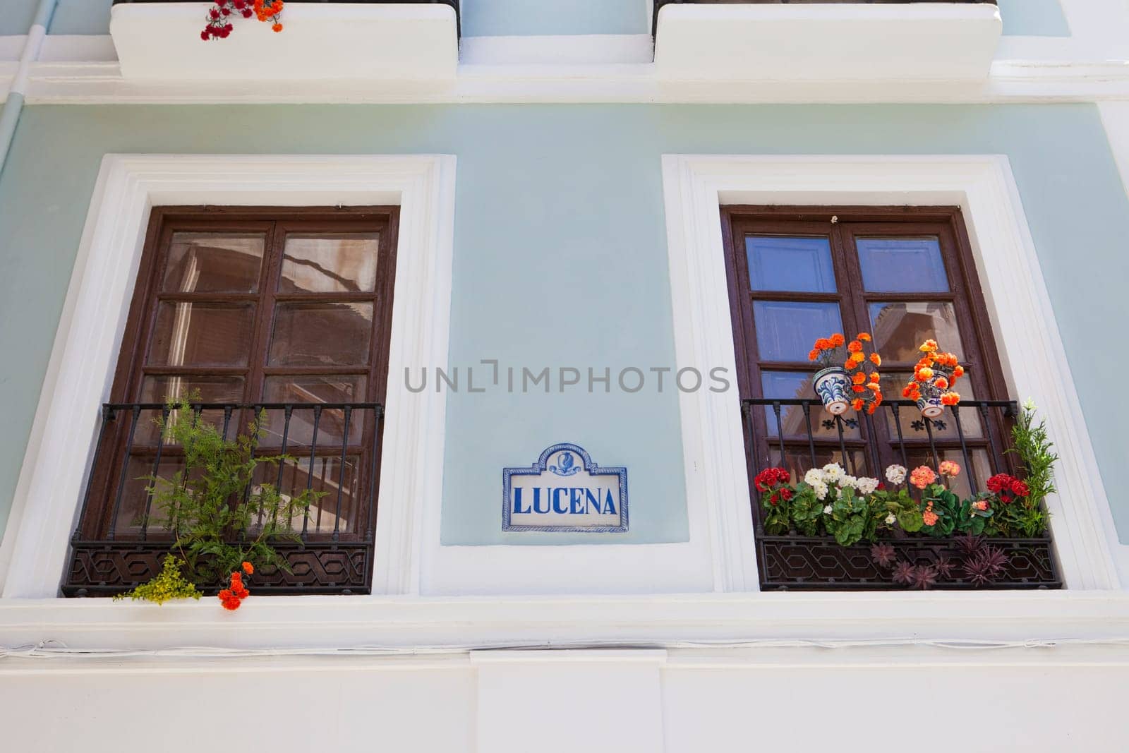 A wall of a house with balcony and flowerpots, Granada, Spain