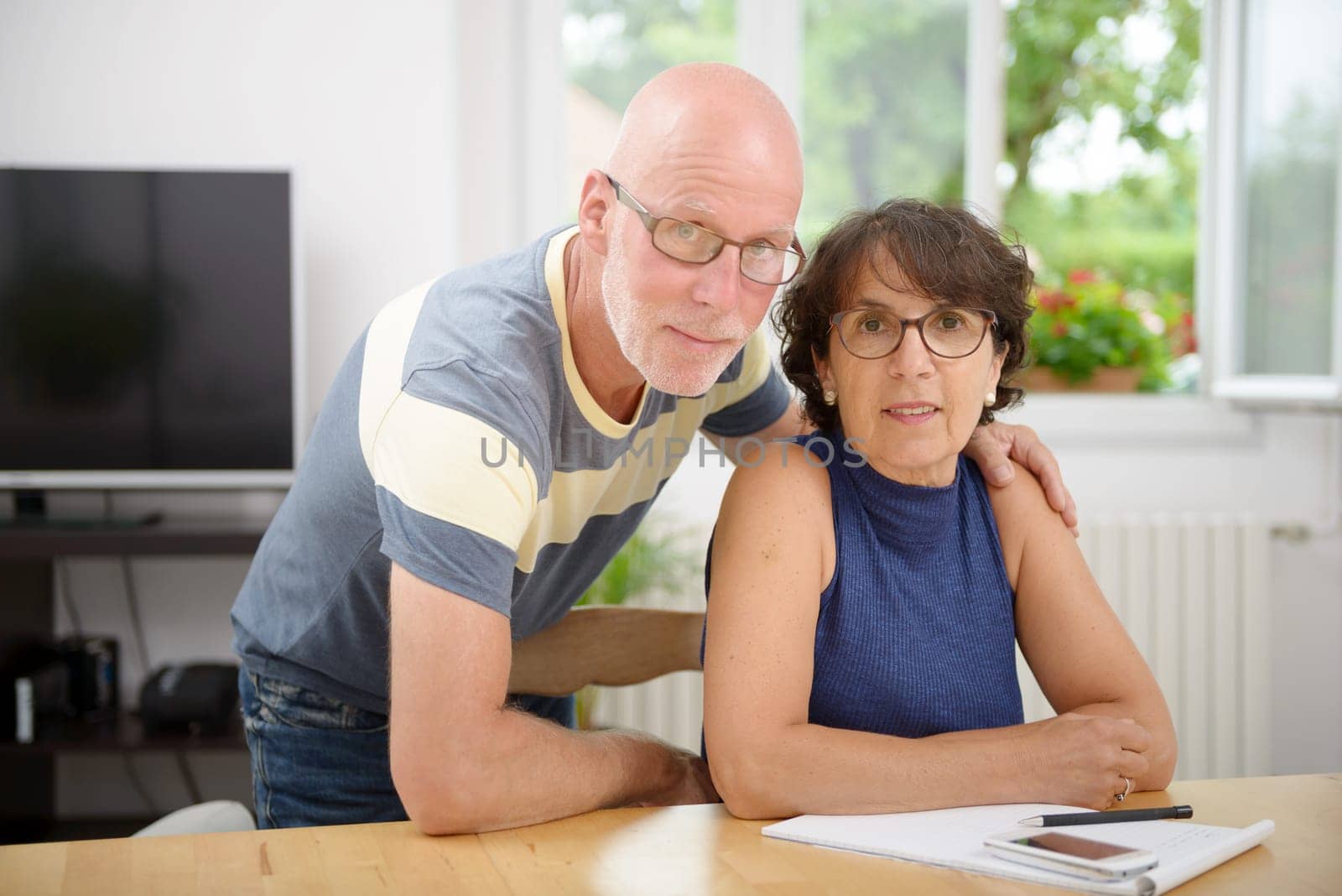 a portrait of a senior couple in their home
