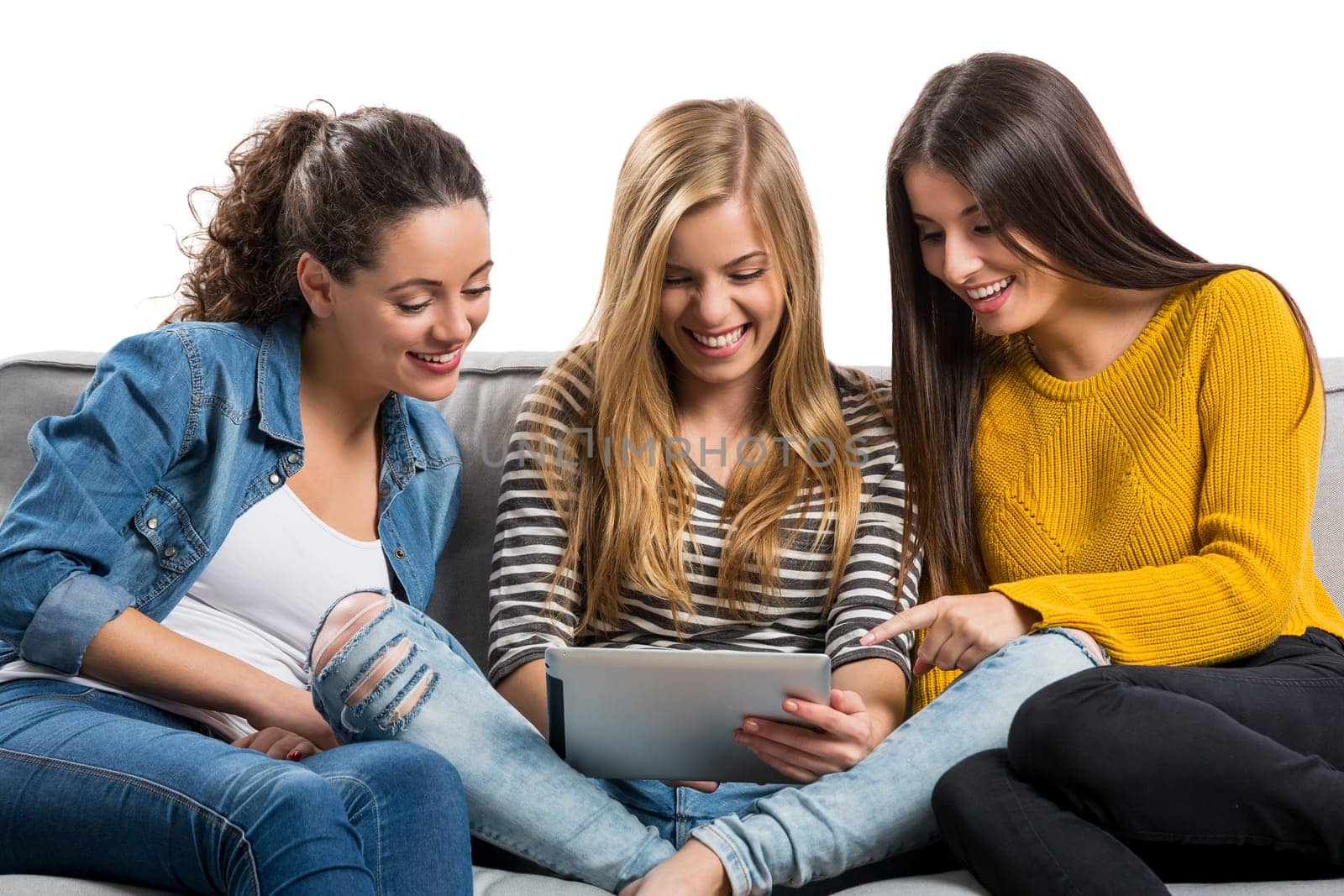 Happy teen girls studying at home with a laptop
