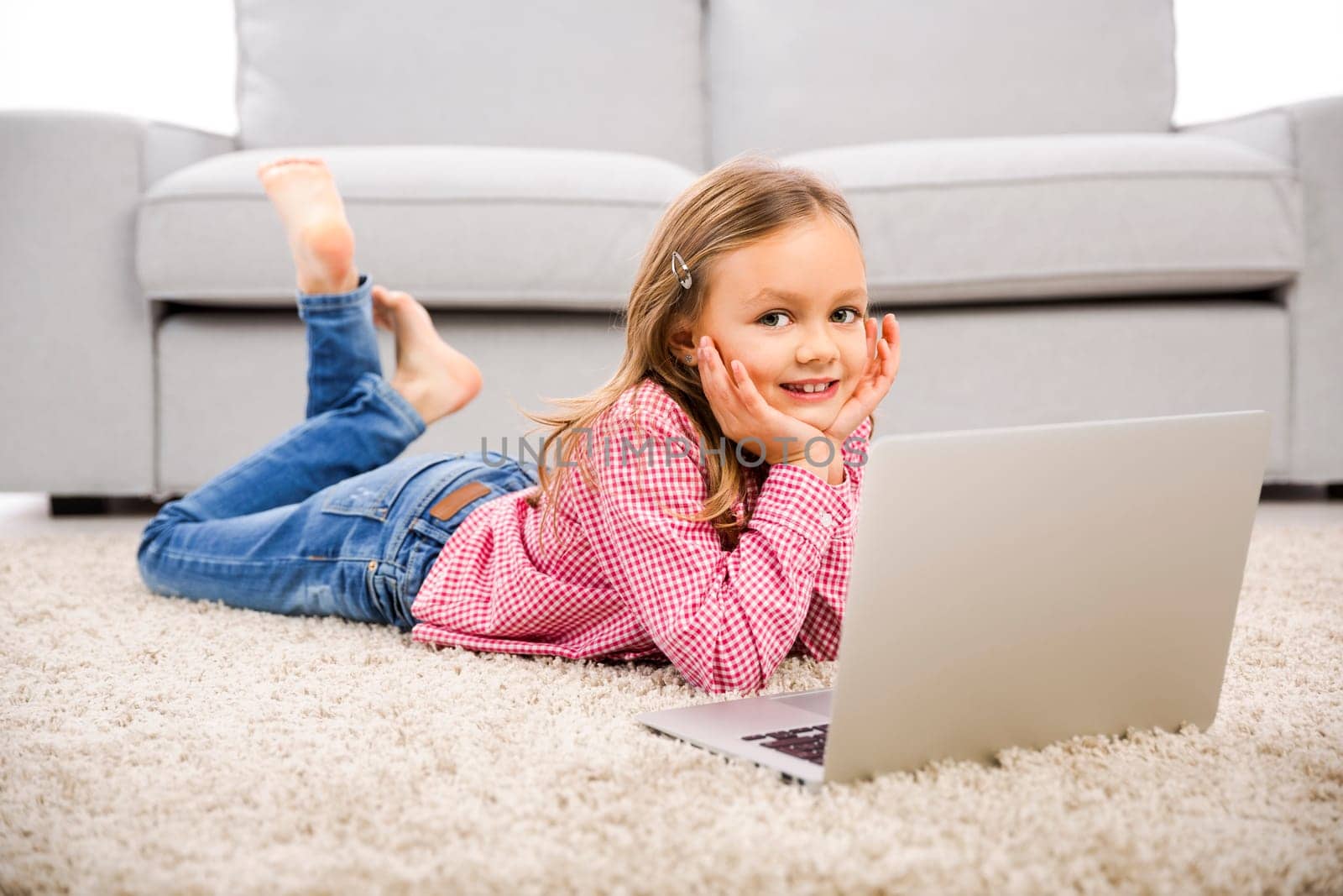 Cute little girl at home studying