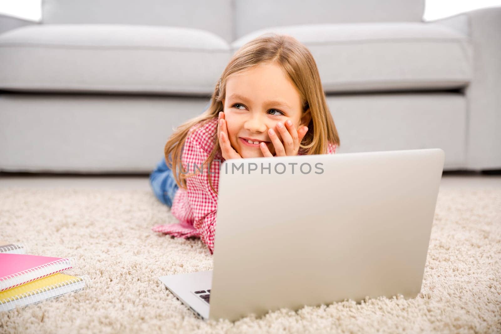 Cute little girl at home studying