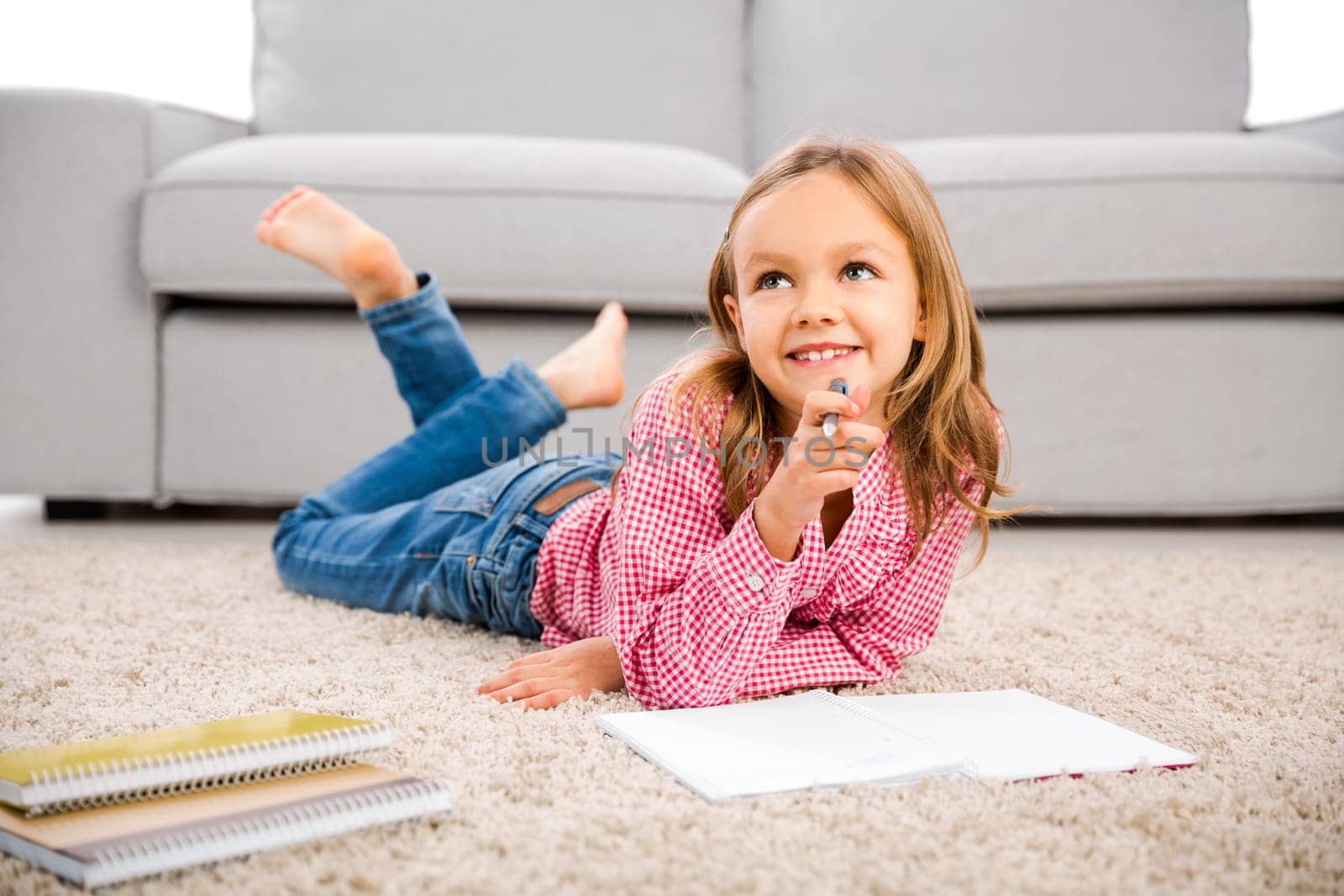 Cute little girl at home studying