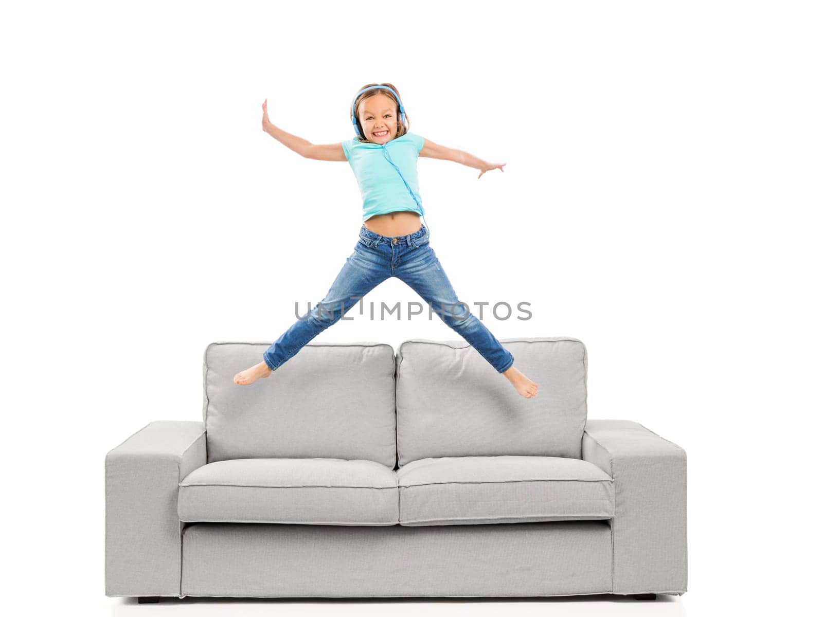 Cute blonde girl jumping and listen music