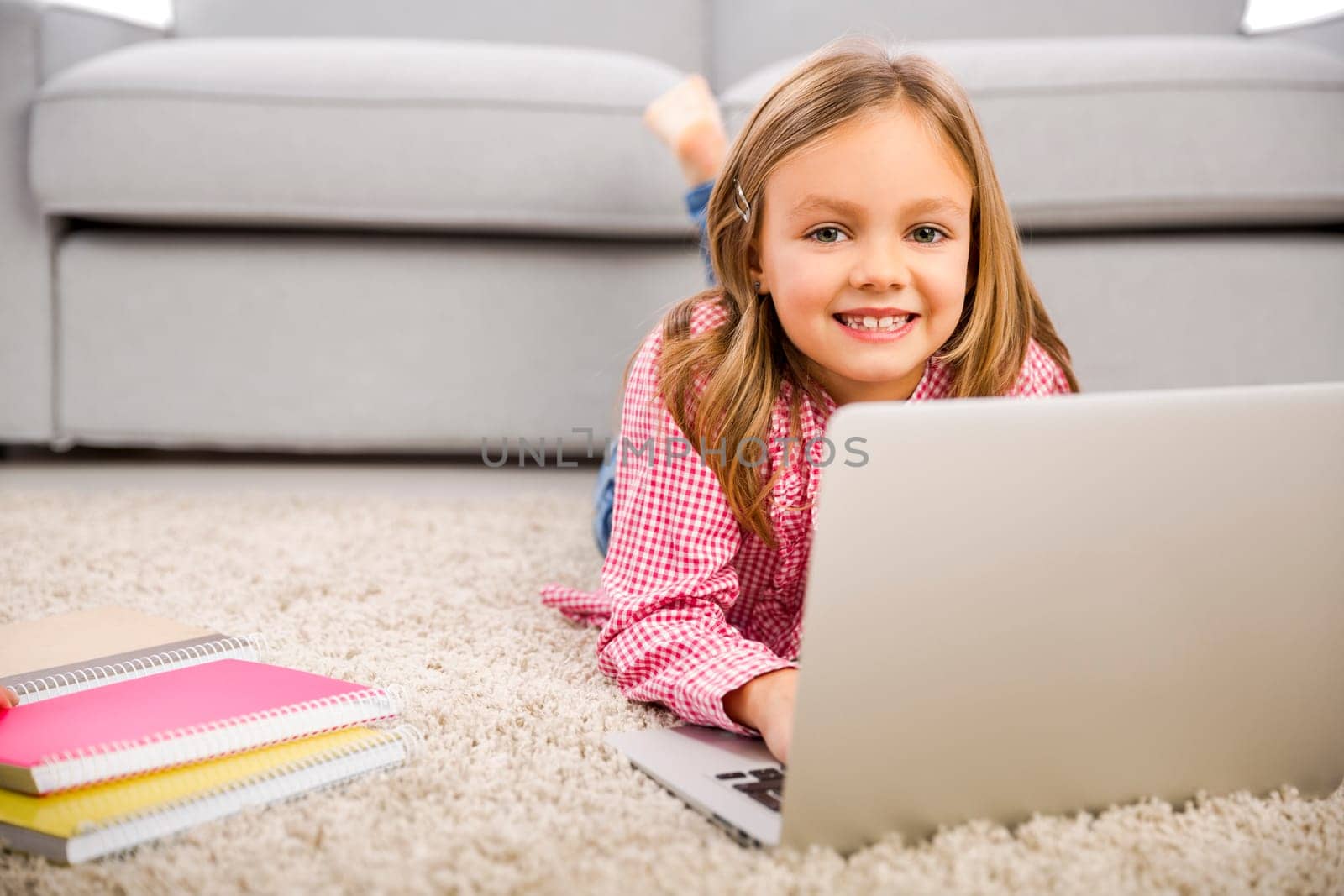 Cute little girl at home studying